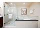 Modern bathroom featuring a glass shower and a luxurious soaking tub at 145 E Harmon Ave # 2503, Las Vegas, NV 89109