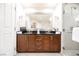 Modern bathroom with double sinks, granite counters, and a glass-enclosed shower at 145 E Harmon Ave # 2503, Las Vegas, NV 89109