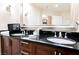Bathroom vanity with granite counters, a large mirror, and stylish fixtures at 145 E Harmon Ave # 2503, Las Vegas, NV 89109