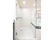 Bright, tiled walk-in shower featuring a partial glass enclosure and a soaking tub next to it at 145 E Harmon Ave # 2503, Las Vegas, NV 89109