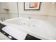 Close up of a Luxurious white soaking tub with jets and tiled surround at 145 E Harmon Ave # 2503, Las Vegas, NV 89109