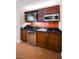 Compact kitchenette featuring modern appliances, dark cabinets, and a sleek design at 145 E Harmon Ave # 2503, Las Vegas, NV 89109