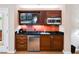 Modern kitchenette featuring a TV, stainless steel microwave, and sleek black countertop for easy meal prep at 145 E Harmon Ave # 819, Las Vegas, NV 89109