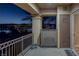 Balcony view overlooking Lake Las Vegas at dusk, with palm trees and city lights visible in the distance at 15 Via Mantova # 303, Henderson, NV 89011