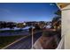 Balcony view overlooking Lake Las Vegas at dusk, featuring a nearby basketball court and city lights at 15 Via Mantova # 303, Henderson, NV 89011