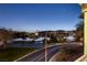 Night view from a balcony overlooking Lake Las Vegas, featuring a nearby basketball court and city lights at 15 Via Mantova # 303, Henderson, NV 89011