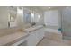 Elegant bathroom boasts marble counters, dual sinks, walk-in shower, and soaking tub at 15 Via Mantova # 303, Henderson, NV 89011