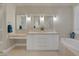 Luxurious primary bathroom features dual sinks, vanity, and a soaking tub at 15 Via Mantova # 303, Henderson, NV 89011