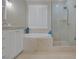 Bright bathroom features marble-look tile, soaking tub, and glass-enclosed shower at 15 Via Mantova # 303, Henderson, NV 89011