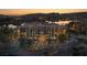 Stunning evening view of lakefront condominiums featuring lush landscaping and manicured grounds at 15 Via Mantova # 303, Henderson, NV 89011