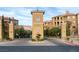 Impressive community entrance with a stone sign, wrought iron details and lush landscaping at 15 Via Mantova # 303, Henderson, NV 89011