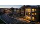 Beautifully illuminated condos featuring balconies and lake views as seen from across the street at 15 Via Mantova # 303, Henderson, NV 89011