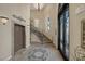 Elegant entryway showcasing a decorative mosaic floor, staircase, and ornate glass doors at 15 Via Mantova # 303, Henderson, NV 89011