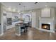 Gourmet kitchen featuring a center island, fireplace, pendant lighting, stainless steel appliances, and custom cabinetry at 15 Via Mantova # 303, Henderson, NV 89011