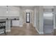 Gourmet kitchen with breakfast bar, pendant lights, stainless steel refrigerator and decorative front door at 15 Via Mantova # 303, Henderson, NV 89011
