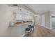 Spacious kitchen featuring bar seating, pendant lights, custom cabinets and stainless steel appliances at 15 Via Mantova # 303, Henderson, NV 89011