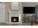 A cozy living room featuring a white fireplace, mantle, and stylish decor at 15 Via Mantova # 303, Henderson, NV 89011