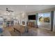 Open concept space with a fireplace, tile floors, a TV, and adjoined to the kitchen at 15 Via Mantova # 303, Henderson, NV 89011