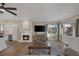 Open-concept living space featuring fireplace, windows, tile floors, and comfortable seating at 15 Via Mantova # 303, Henderson, NV 89011