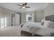 Bright main bedroom features plush carpet, neutral walls, and a large window with natural light at 15 Via Mantova # 303, Henderson, NV 89011