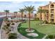 Scenic view of community putting green, pool, and condos with lake and mountain views at 15 Via Mantova # 303, Henderson, NV 89011