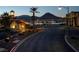 Street view of illuminated buildings with palm trees and desert mountain views at 15 Via Mantova # 303, Henderson, NV 89011