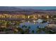 Waterfront community at dusk featuring boat docks, terracotta rooftops, and mountain views at 15 Via Mantova # 303, Henderson, NV 89011
