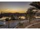 Beautiful waterfront view of a lakefront community at sunset with palm trees, mountains and nearby houses at 15 Via Mantova # 303, Henderson, NV 89011