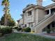 Beautiful condo exterior featuring stucco facade, stairway access, lush landscaping, and a red tile roof at 1501 Lake Placid Ter # 0, Henderson, NV 89014