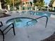Relaxing community hot tub area with nearby lounge seating and views of palm trees at 1501 Lake Placid Ter # 0, Henderson, NV 89014