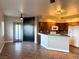 Open kitchen and living space with dark cabinetry, modern appliances, and tiled floors at 1501 Lake Placid Ter # 0, Henderson, NV 89014