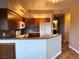 Contemporary kitchen featuring dark wood cabinets, tile flooring, stone countertops, and stainless steel appliances at 1501 Lake Placid Ter # 0, Henderson, NV 89014
