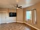 Cozy living room featuring tile flooring, a ceiling fan, a TV, and a bright window at 1501 Lake Placid Ter # 0, Henderson, NV 89014