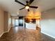 Bright open-concept living space featuring tile floors, a kitchen, and a ceiling fan at 1501 Lake Placid Ter # 0, Henderson, NV 89014