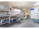 Well-organized garage area with utility sink, cabinets, storage and a workbench for hobbies at 1744 Marshall Dr, Henderson, NV 89014