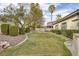 Manicured backyard featuring lush landscaping, gravel accents, and beautiful lawn at 1901 Rosemere Ct, Las Vegas, NV 89117