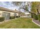 Expansive backyard features a lush lawn, mature trees, and a sparkling pool, perfect for outdoor relaxation and entertainment at 1901 Rosemere Ct, Las Vegas, NV 89117