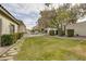 Large backyard featuring lush landscaping, stone walkway, and serene pool views at 1901 Rosemere Ct, Las Vegas, NV 89117