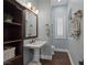 Bathroom featuring a pedestal sink, wood-look floors, and built-in decorative shelving at 1901 Rosemere Ct, Las Vegas, NV 89117