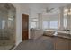 Luxury bathroom with a large vanity, soaking tub, glass shower, and column accents at 1901 Rosemere Ct, Las Vegas, NV 89117