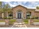 Inviting home entrance featuring a beautifully landscaped yard and stately brick columns at 1901 Rosemere Ct, Las Vegas, NV 89117