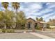 Charming single-story home boasts an inviting facade with brick accents, an arched entryway, and lush landscaping at 1901 Rosemere Ct, Las Vegas, NV 89117