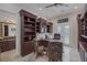 Spacious home office features custom built-ins, tile flooring, and bright natural light through french doors at 1901 Rosemere Ct, Las Vegas, NV 89117