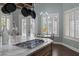 Kitchen island with built-in cooktop and views of the backyard at 1901 Rosemere Ct, Las Vegas, NV 89117