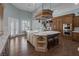 Gourmet kitchen with a marble island, pot rack, and stainless steel appliances at 1901 Rosemere Ct, Las Vegas, NV 89117