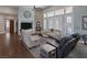 Bright living room boasts a stone fireplace, high ceilings, fan, and a large window with shutters at 1901 Rosemere Ct, Las Vegas, NV 89117
