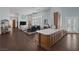 Spacious living room with fireplace and adjoining kitchen with a long island and wood cabinets at 1901 Rosemere Ct, Las Vegas, NV 89117