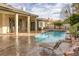 Backyard featuring a sparkling pool, spa, covered patio, and lounge chairs for outdoor enjoyment at 1901 Rosemere Ct, Las Vegas, NV 89117