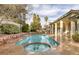 Backyard featuring a sparkling pool, spa, rock waterfall, and covered patio for outdoor enjoyment at 1901 Rosemere Ct, Las Vegas, NV 89117