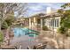 Backyard featuring a sparkling pool, spa, covered patio, and beautiful desert landscaping at 1901 Rosemere Ct, Las Vegas, NV 89117